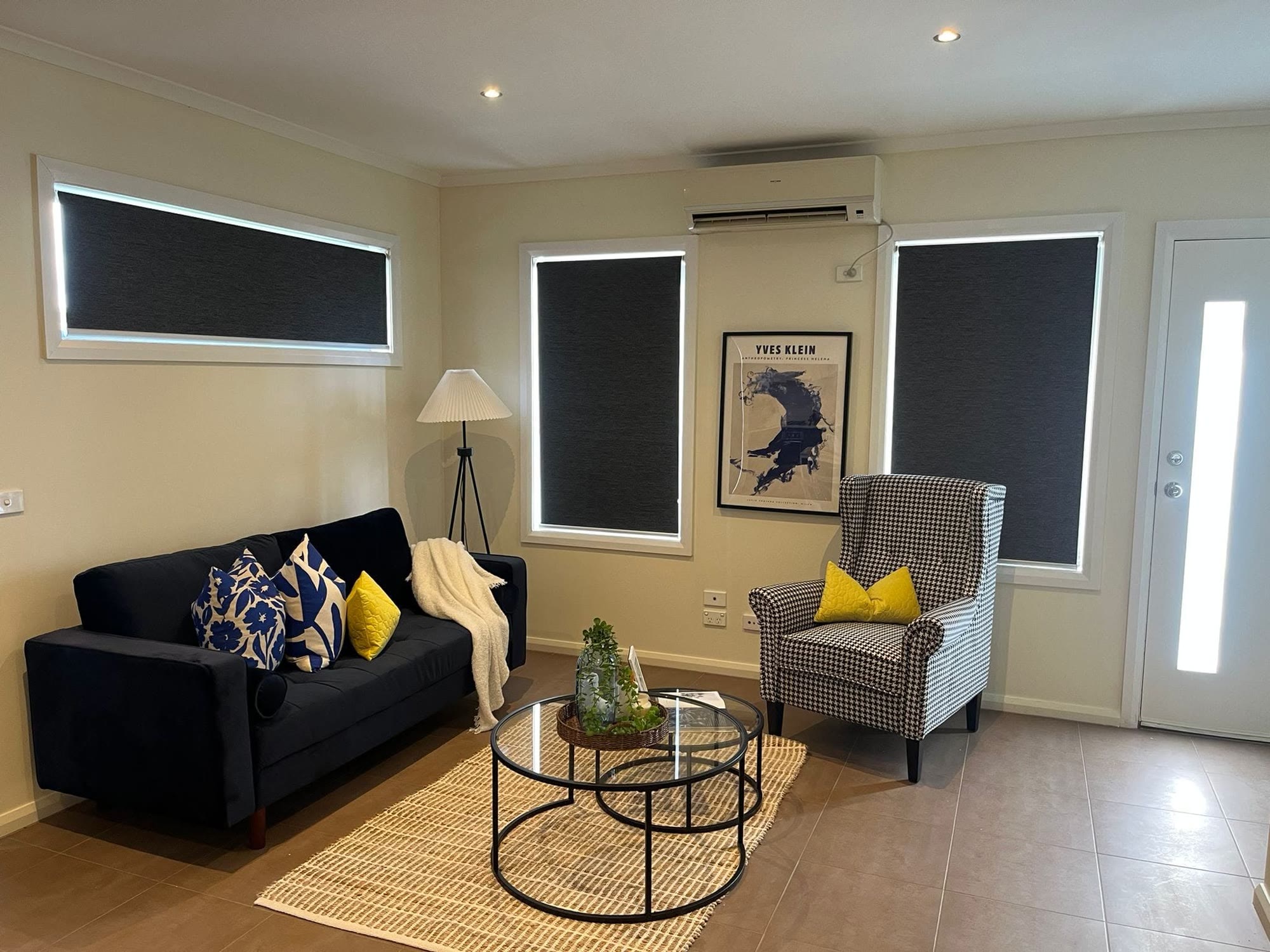 Blockout roller blinds across a living-room wall
