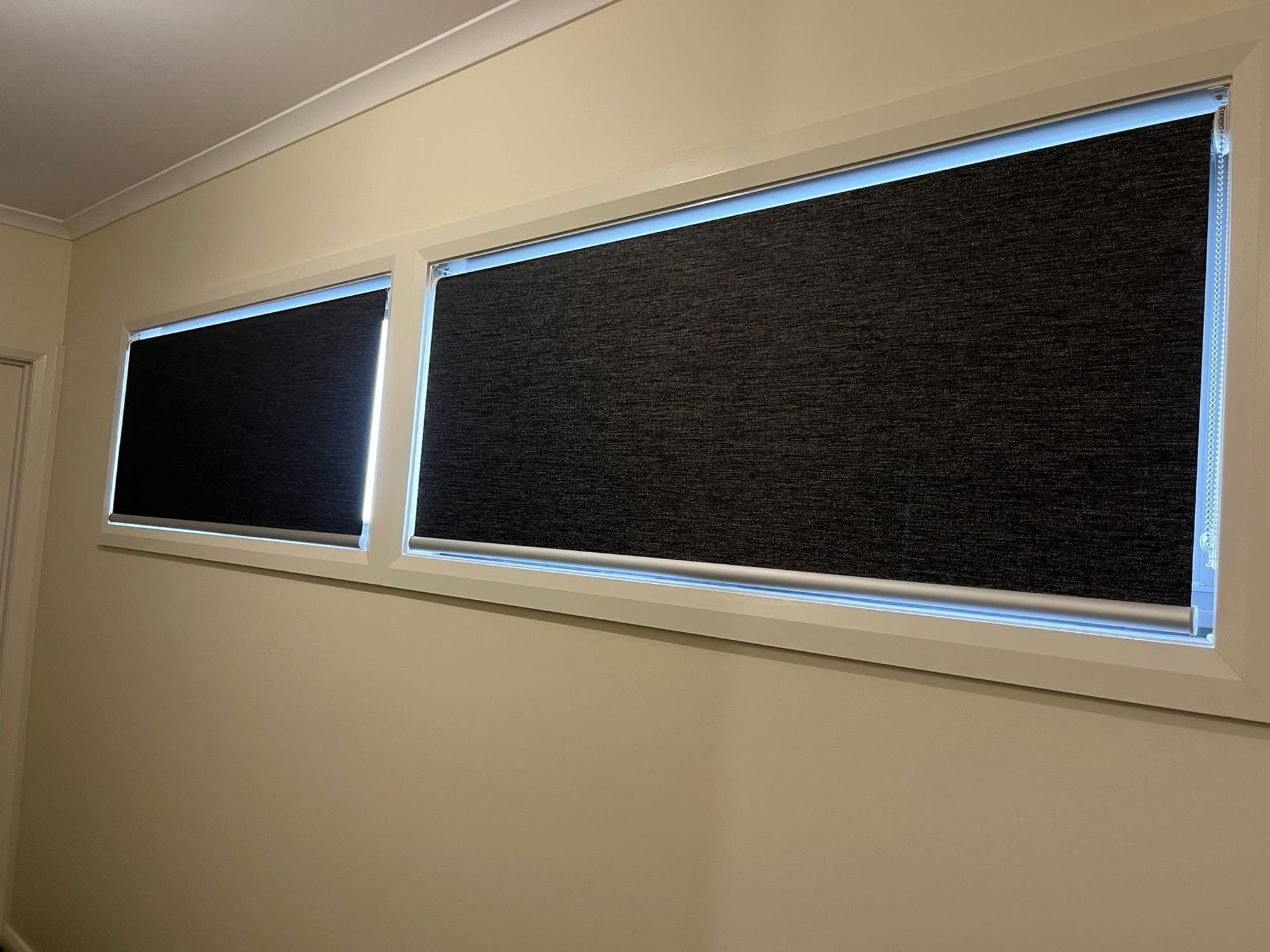 Blockout roller blinds on wide living-room windows
