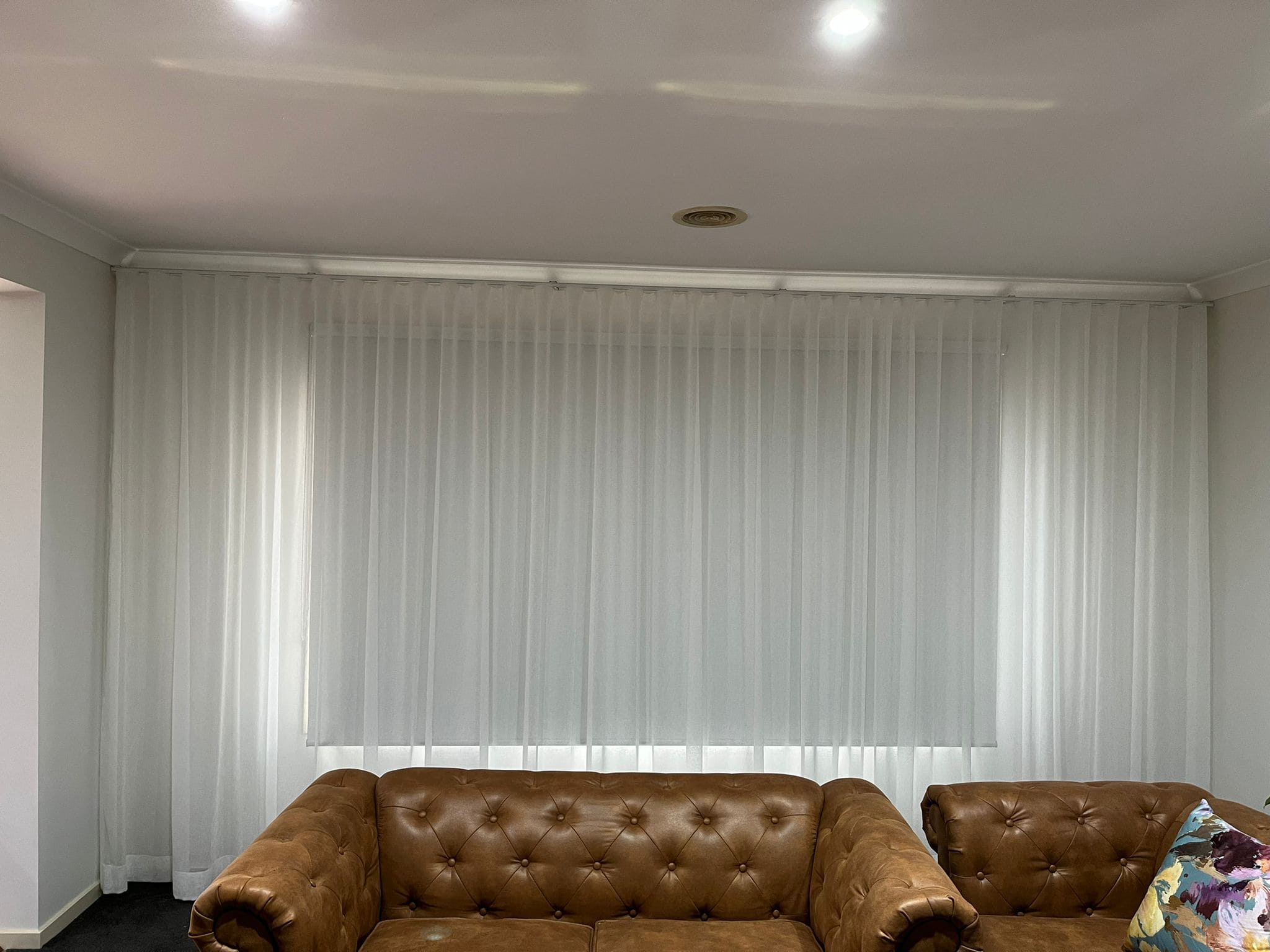 White sheer curtains on a wide living-room window
