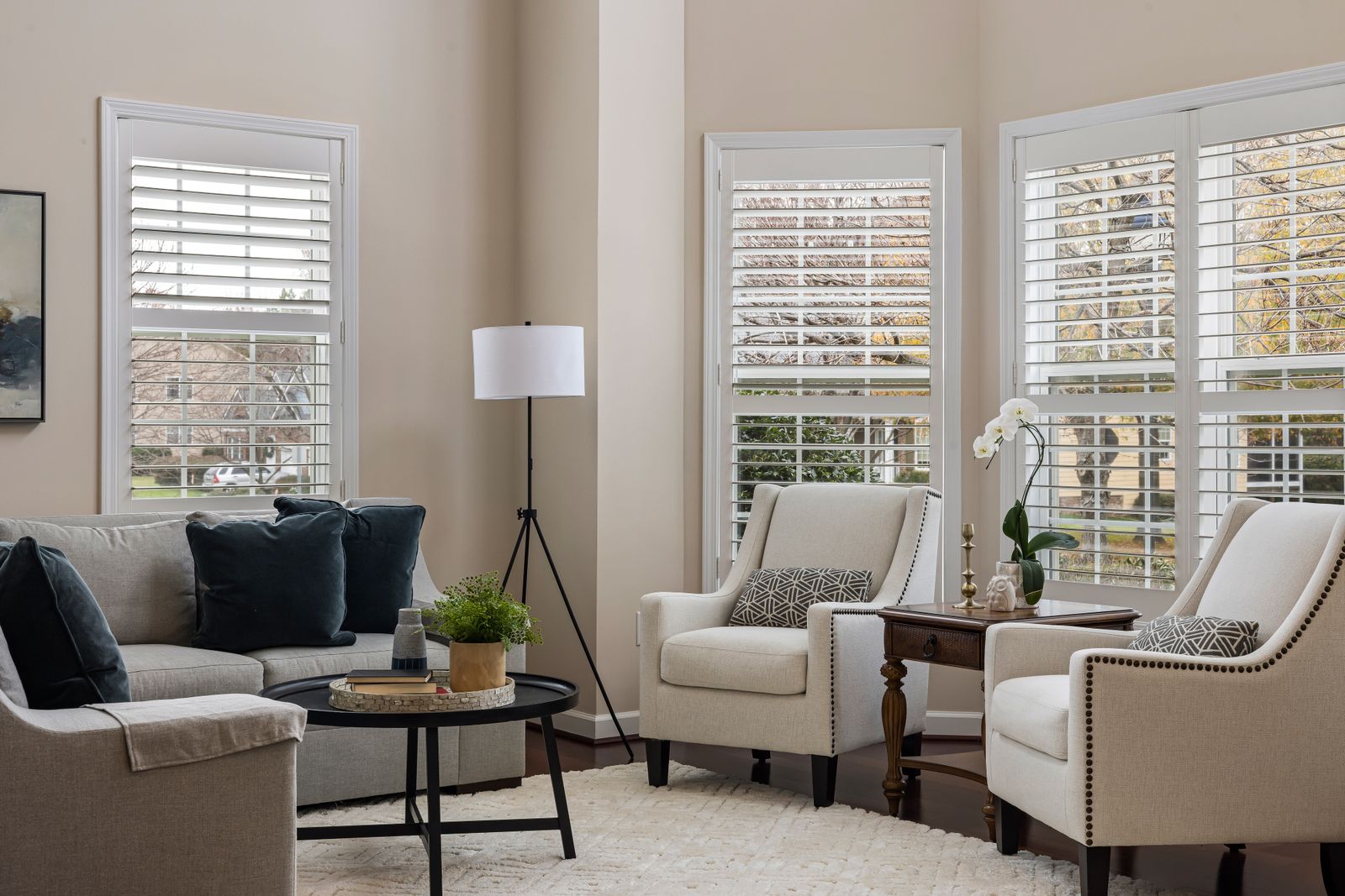 White plantation shutters across a formal lounge