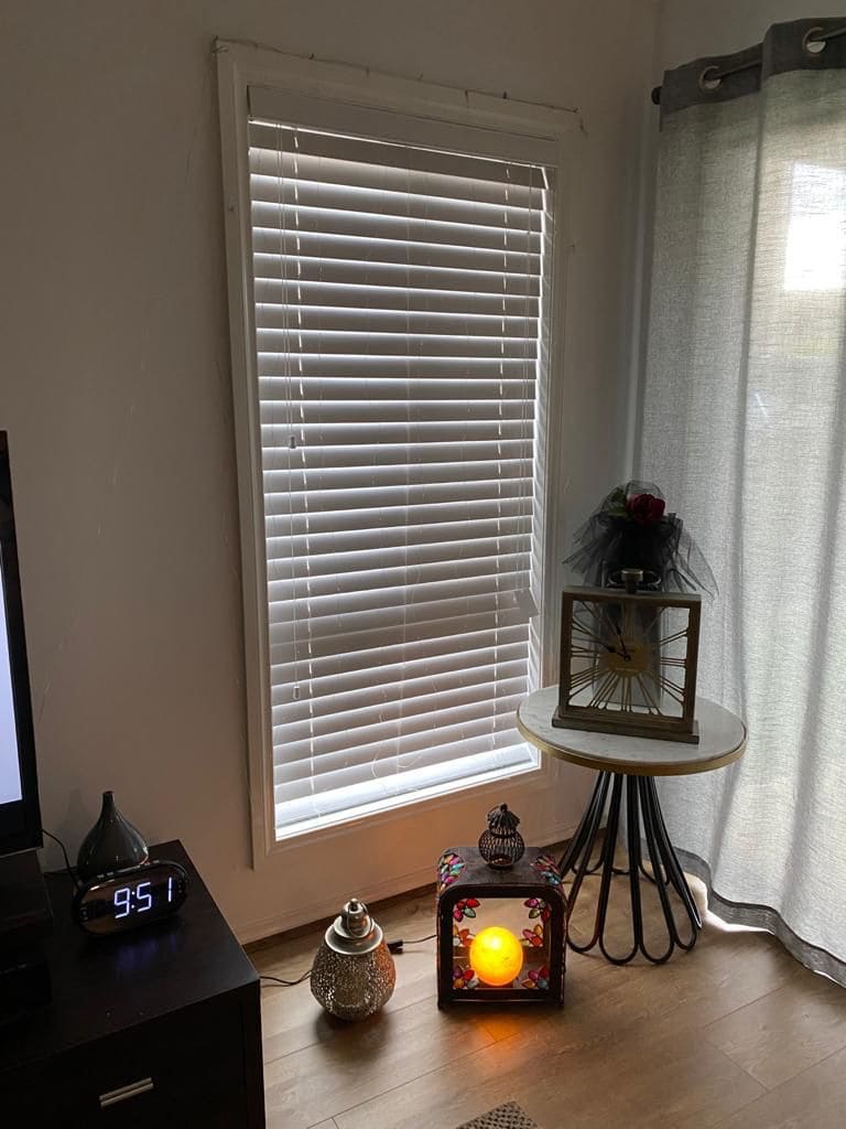 Venetian blinds beside a grommet sheer